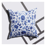 A cushion cover with a flower design and leafy details